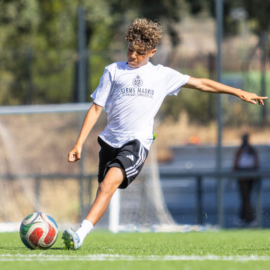 Forms Madrid player strikes the ball during a morning training session