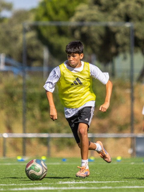 Player drives forward with the ball at his feet during a training exercise